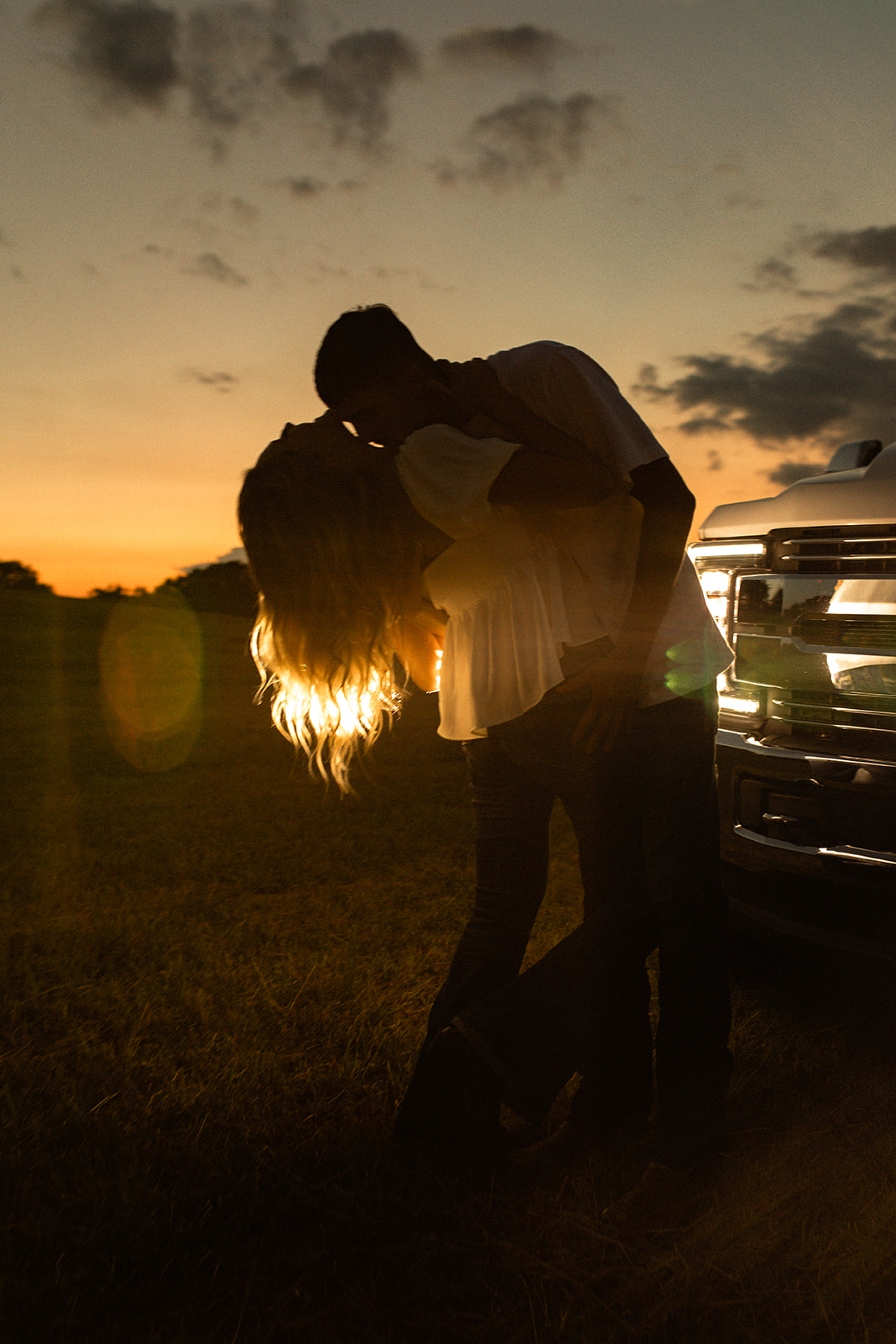 Couple in a field with a truck