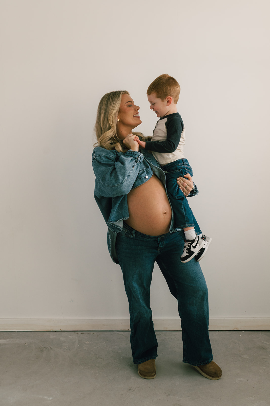 A mom and son in the photo studio for maternity photos
